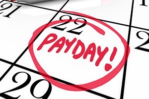 The word payday circled in red marker on a calendar