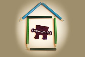 A house symbol make from color pencil and puzzle with word conveyancing