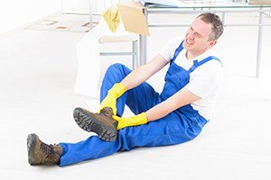 Man worker with ankle injury concept of accident at work