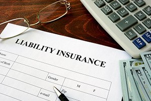 Liability insurance form and dollars on the table