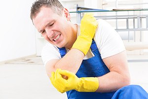 Man worker with elbow injury, concept of accident at work