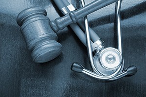 Gravel and stethoscope on wooden background