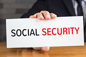 Social security, message on white card and hold by businessman