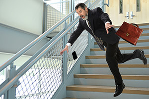 Businessman falling on stairs