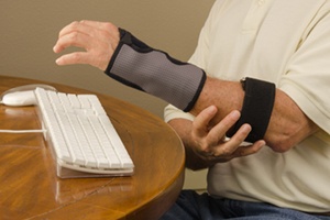 A man is experiencing computr use pain with tendinitis