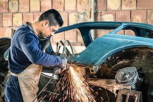 Young man mechanical worker repairing and old vintage