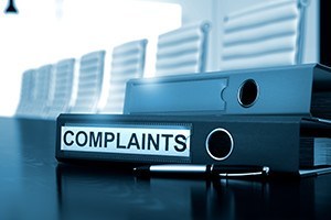 Complaints office binder on office desktop