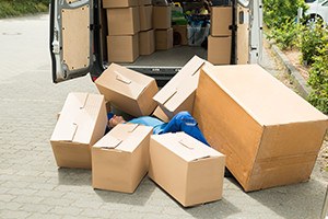 Unconscious Male Worker Lying On Street Surrounded With Boxes