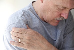 Man suffering from aching shoulder