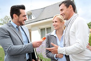 Salesman giving home keys