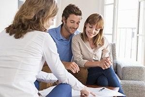 Real estate agent presenting a contract for house investment to futur owners couple