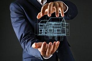 Real estate offer. Businessman holds an artificial model of the house