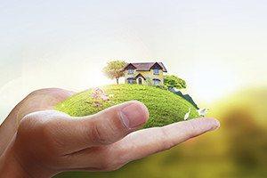 Business man house in human hands