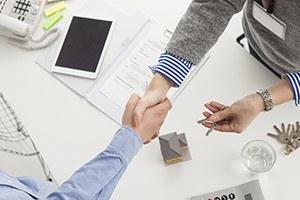 Handshake of a real estate agent and a visitor
